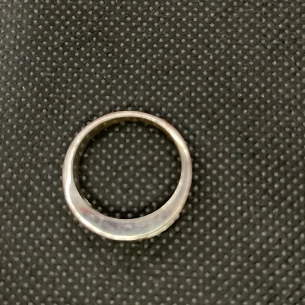 Metal ring with a row of white gems